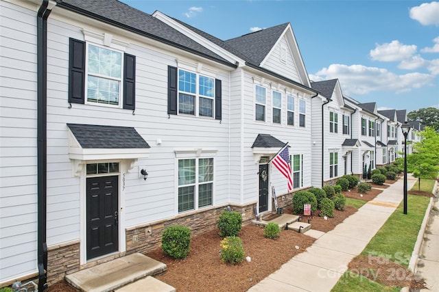5037 Patton Dr, Gastonia, NC 28056 - view of property featuring stone siding, a residential view, and roof with shingles