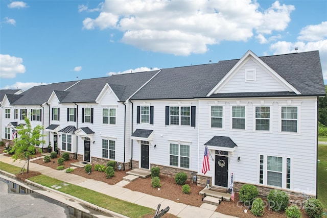 5037 Patton Dr, Gastonia, NC 28056 - view of property featuring stone siding, a residential view, and roof with shingles