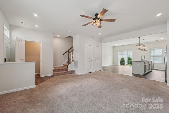 5037 Patton Dr, Gastonia, NC 28056 - unfurnished living room featuring dark colored carpet, recessed lighting, a ceiling fan, stairway, and dark wood-style floors