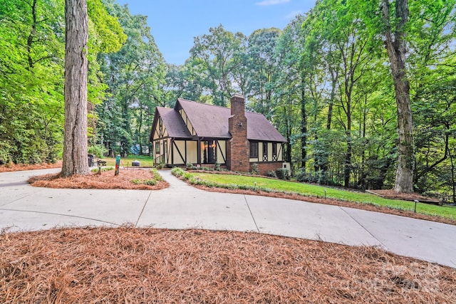 3920 Tilley Morris Rd, Matthews, NC 28105 - tudor home featuring a chimney