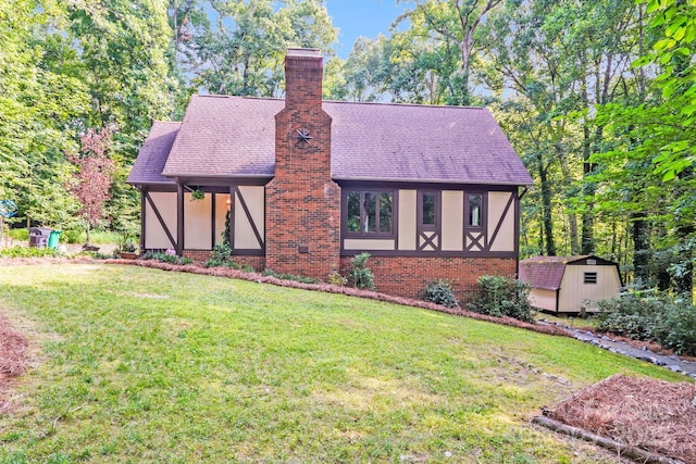 3920 Tilley Morris Rd, Matthews, NC 28105 - english style home featuring a shed, a front yard, a chimney, a shingled roof, and brick siding