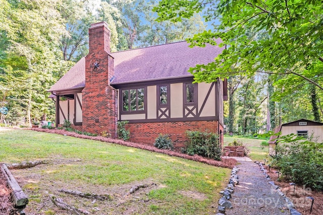 3920 Tilley Morris Rd, Matthews, NC 28105 - tudor home with stucco siding, a chimney, roof with shingles, brick siding, and a front yard