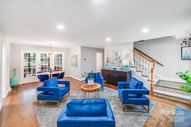 3920 Tilley Morris Rd, Matthews, NC 28105 - living room with stairs, recessed lighting, wood finished floors, and a chandelier