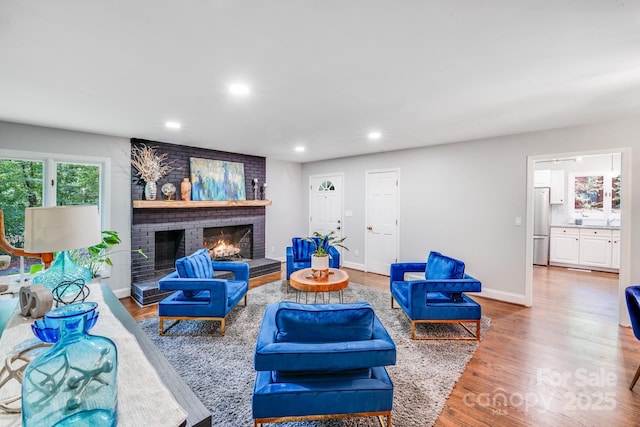 3920 Tilley Morris Rd, Matthews, NC 28105 - living room featuring recessed lighting, a brick fireplace, and wood finished floors