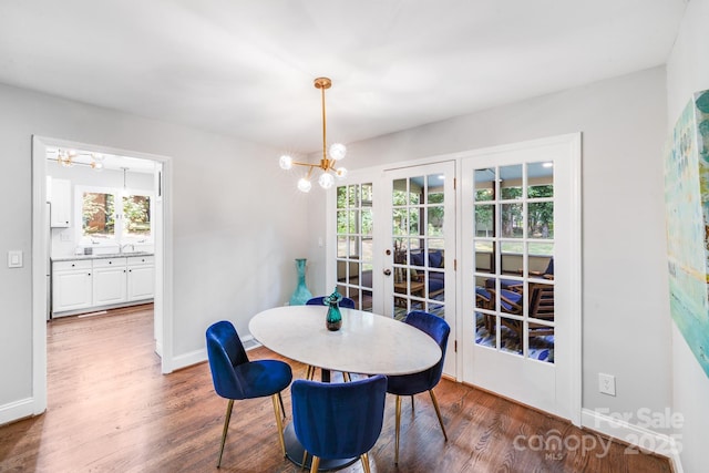3920 Tilley Morris Rd, Matthews, NC 28105 - dining space with a chandelier, french doors, and wood finished floors