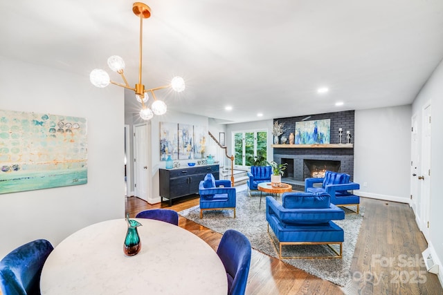 3920 Tilley Morris Rd, Matthews, NC 28105 - living area with stairway, wood finished floors, a fireplace, recessed lighting, and a chandelier