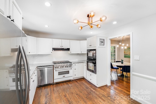 3920 Tilley Morris Rd, Matthews, NC 28105 - kitchen featuring a chandelier, black appliances, dark wood-style flooring, tasteful backsplash, and recessed lighting
