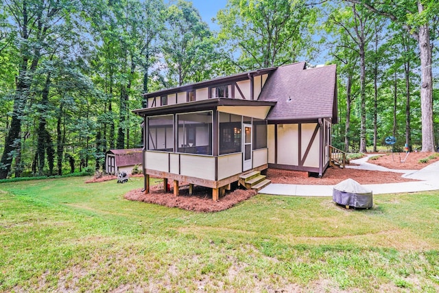 3920 Tilley Morris Rd, Matthews, NC 28105 - rear view of property with a sunroom, a yard, a shingled roof, and stucco siding