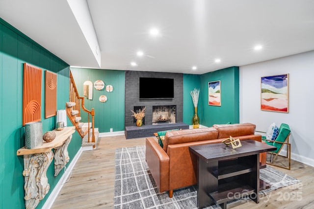 3920 Tilley Morris Rd, Matthews, NC 28105 - living area featuring stairs, a brick fireplace, recessed lighting, and light wood-style flooring