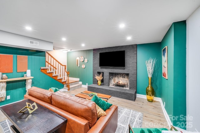 3920 Tilley Morris Rd, Matthews, NC 28105 - living area with a fireplace, stairway, wood finished floors, and recessed lighting