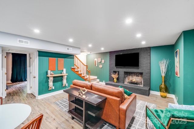 3920 Tilley Morris Rd, Matthews, NC 28105 - living room featuring stairs, a fireplace, wood finished floors, and recessed lighting