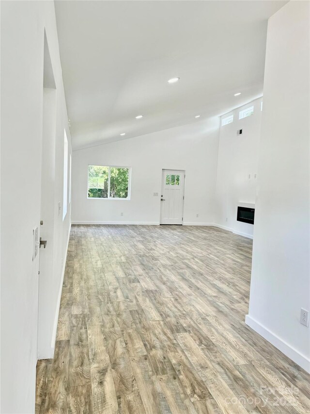 900 Linney Ln, Shelby, NC 28152 - spare room featuring lofted ceiling, wood finished floors, recessed lighting, and a fireplace