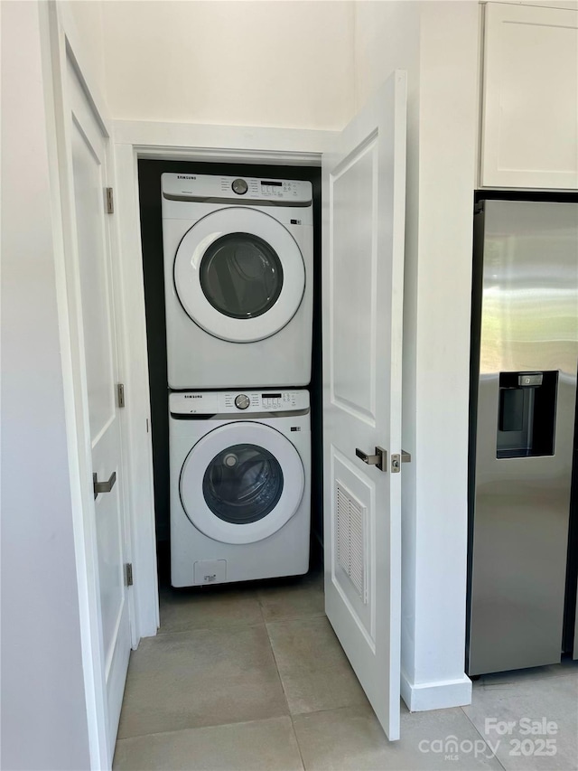 900 Linney Ln, Shelby, NC 28152 - laundry area featuring estacked washer and dryer and light tile patterned floors