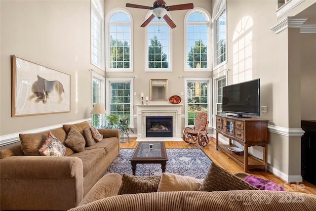 6123 Abergele Ln, Matthews, NC 28104 - living area featuring a ceiling fan, a fireplace with flush hearth, plenty of natural light, and a high ceiling