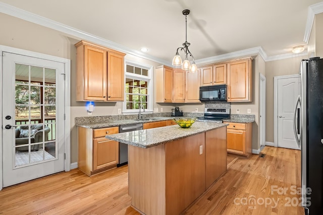 6123 Abergele Ln, Matthews, NC 28104 - kitchen with appliances with stainless steel finishes, crown molding, a center island, light wood finished floors, and light stone countertops