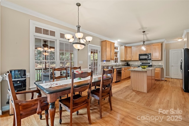 6123 Abergele Ln, Matthews, NC 28104 - dining room featuring crown molding, light wood-type flooring, and a chandelier