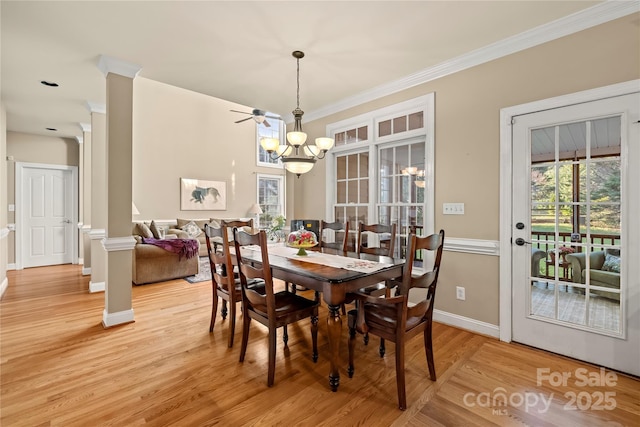 6123 Abergele Ln, Matthews, NC 28104 - dining room featuring ornamental molding, light wood-style floors, a chandelier, and decorative columns