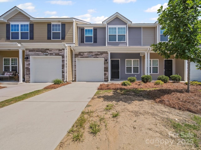 15239 Wrights Crossing Dr, Charlotte, NC 28278 - view of front of home featuring an attached garage, concrete driveway, covered porch, and stone siding