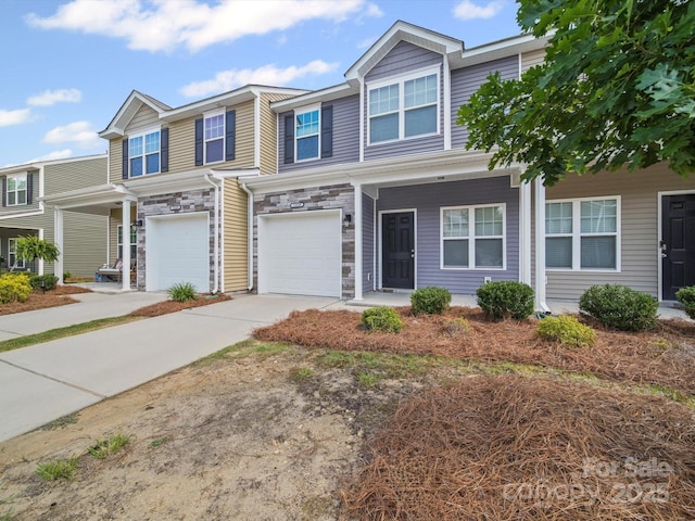 15239 Wrights Crossing Dr, Charlotte, NC 28278 - multi unit property featuring a garage, concrete driveway, stone siding, and covered porch
