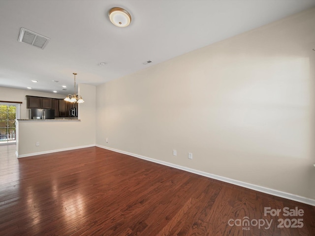 15239 Wrights Crossing Dr, Charlotte, NC 28278 - unfurnished living room with a chandelier, dark wood-type flooring, and recessed lighting