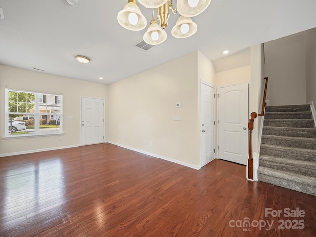 15239 Wrights Crossing Dr, Charlotte, NC 28278 - spare room featuring wood finished floors, stairway, a chandelier, and a smoke detector