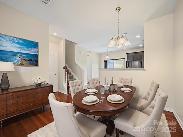 15239 Wrights Crossing Dr, Charlotte, NC 28278 - dining space featuring dark wood-style floors, a chandelier, and stairway