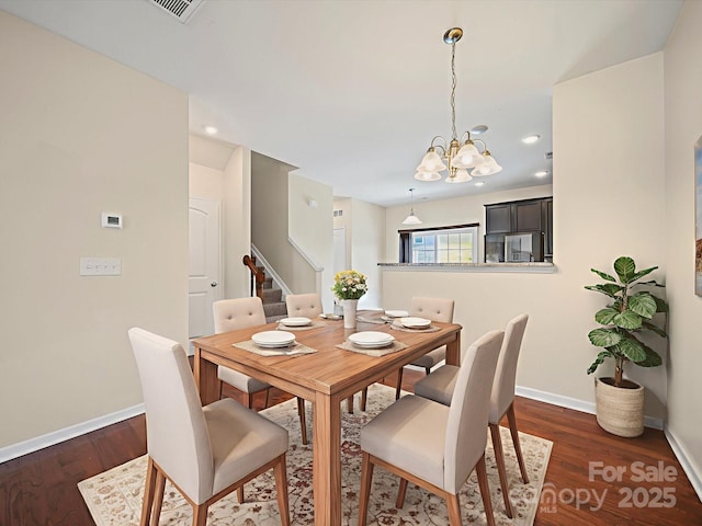 15239 Wrights Crossing Dr, Charlotte, NC 28278 - dining room featuring stairs, a chandelier, and dark wood-type flooring