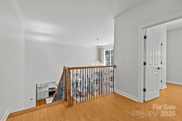 12336 Tantallon Ct, Pineville, NC 28134 - hall with wood finished floors, crown molding, an upstairs landing, and a chandelier