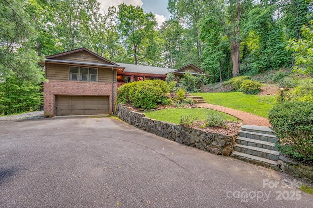 467 Winners Cir, Tryon, NC 28782 - view of front of property with brick siding, driveway, an attached garage, and a front lawn