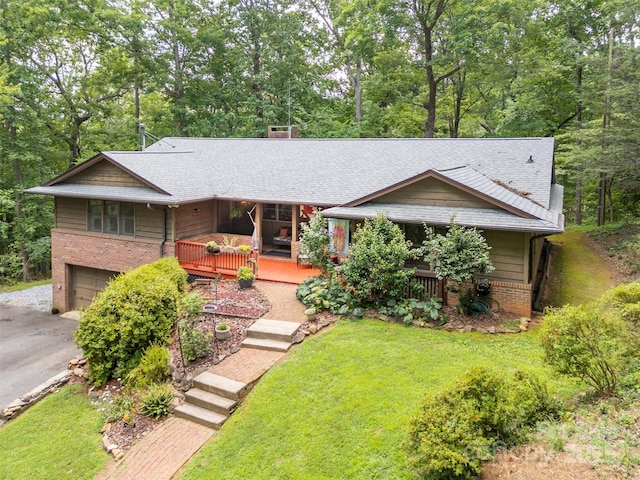 467 Winners Cir, Tryon, NC 28782 - view of front of property featuring a garage, brick siding, asphalt driveway, and roof with shingles