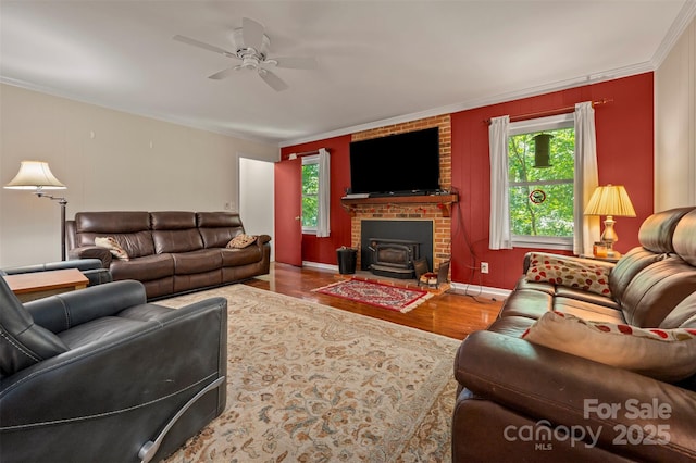 467 Winners Cir, Tryon, NC 28782 - living area with wood finished floors, ornamental molding, a ceiling fan, and a wood stove