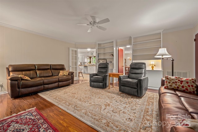 467 Winners Cir, Tryon, NC 28782 - living area with ceiling fan, wood finished floors, crown molding, and built in shelves
