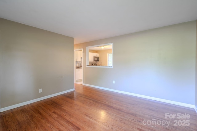 2519 Abelwood Rd, Charlotte, NC 28216 - empty room featuring wood finished floors and baseboards