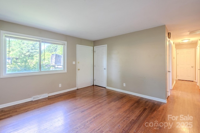 2519 Abelwood Rd, Charlotte, NC 28216 - spare room featuring wood finished floors and baseboards