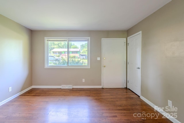 2519 Abelwood Rd, Charlotte, NC 28216 - spare room featuring wood finished floors and baseboards