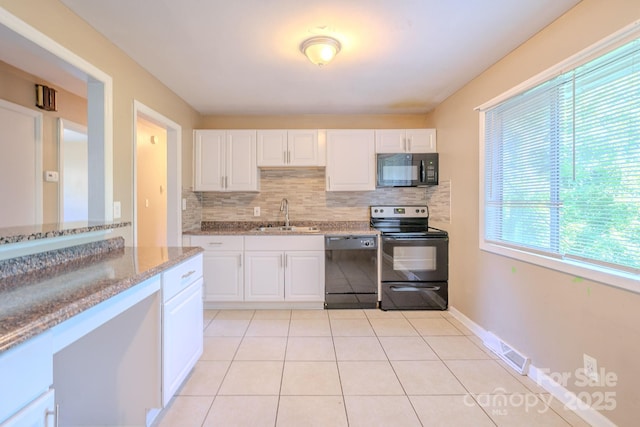 2519 Abelwood Rd, Charlotte, NC 28216 - kitchen featuring black appliances, decorative backsplash, light stone countertops, and white cabinetry