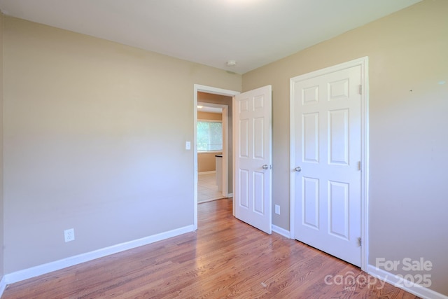 2519 Abelwood Rd, Charlotte, NC 28216 - unfurnished bedroom featuring wood finished floors and baseboards