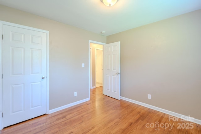 2519 Abelwood Rd, Charlotte, NC 28216 - unfurnished bedroom with baseboards and light wood finished floors