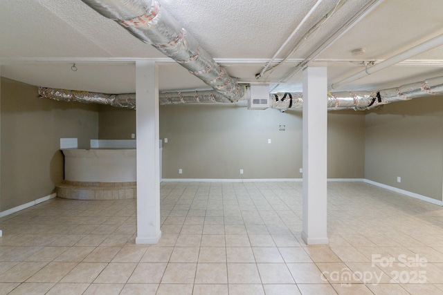 2519 Abelwood Rd, Charlotte, NC 28216 - finished below grade area featuring tile patterned flooring and a textured ceiling