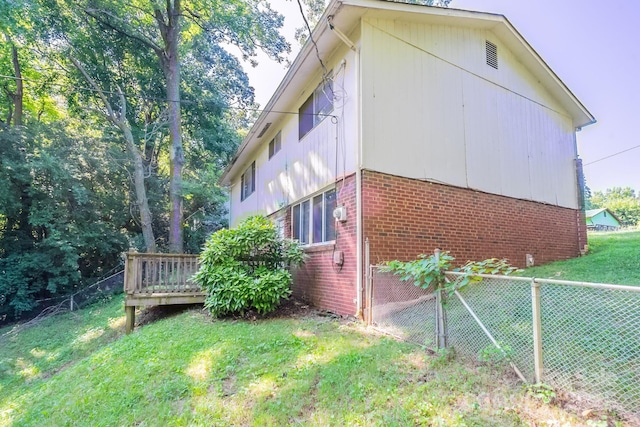 2519 Abelwood Rd, Charlotte, NC 28216 - view of side of property with brick siding and a wooden deck