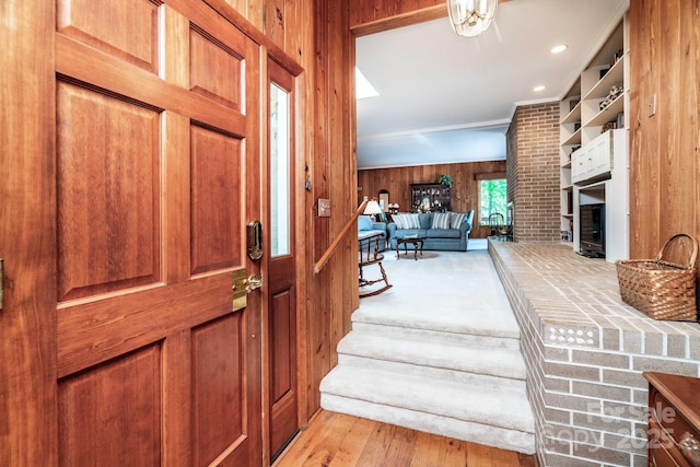8448 Normandy Rd, Denver, NC 28037 - entrance foyer featuring wooden walls, a brick fireplace, and light wood finished floors