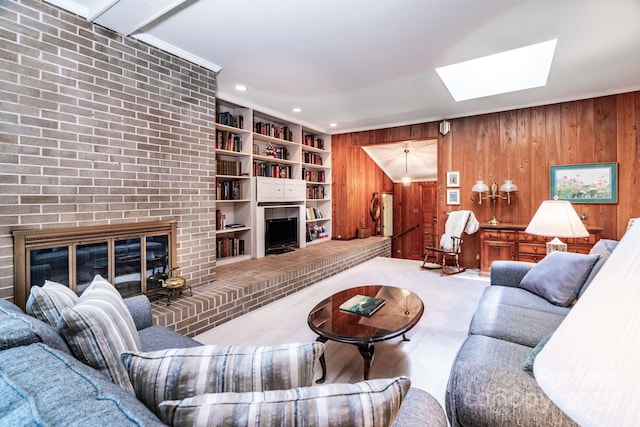 8448 Normandy Rd, Denver, NC 28037 - living area with a fireplace, a skylight, wooden walls, carpet flooring, and recessed lighting