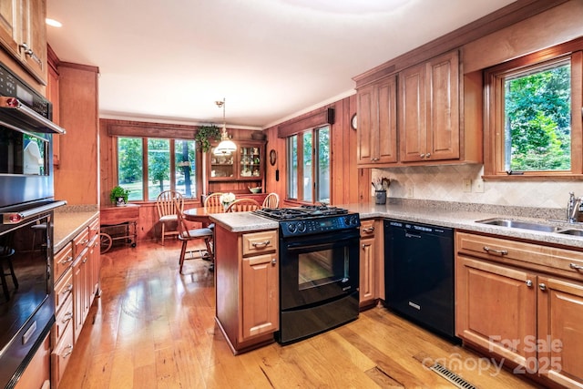 8448 Normandy Rd, Denver, NC 28037 - kitchen with black appliances, a peninsula, light wood-style floors, pendant lighting, and brown cabinets