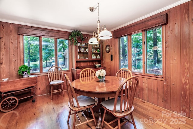8448 Normandy Rd, Denver, NC 28037 - dining area with wood-type flooring, wooden walls, and ornamental molding