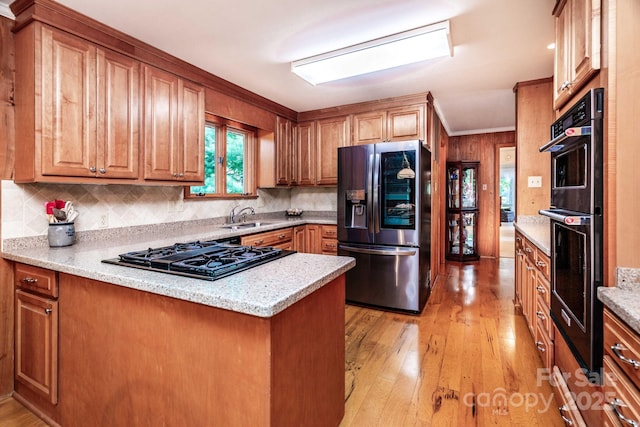 8448 Normandy Rd, Denver, NC 28037 - kitchen with appliances with stainless steel finishes, light wood finished floors, backsplash, a peninsula, and crown molding