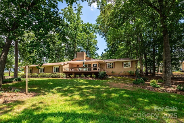 8448 Normandy Rd, Denver, NC 28037 - view of front of property featuring a front lawn, a wooden deck, a chimney, crawl space, and brick siding