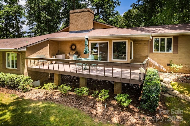 8448 Normandy Rd, Denver, NC 28037 - back of house featuring a chimney, brick siding, a wooden deck, and roof with shingles
