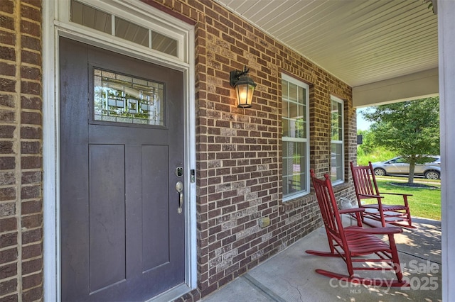 10906 Angler Ct, Davidson, NC 28036 - view of exterior entry with covered porch and brick siding