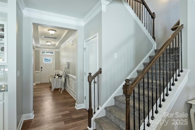 10906 Angler Ct, Davidson, NC 28036 - staircase with wood finished floors, ornamental molding, a tray ceiling, and a decorative wall