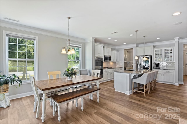 10906 Angler Ct, Davidson, NC 28036 - dining space featuring crown molding, healthy amount of natural light, recessed lighting, and wood finished floors